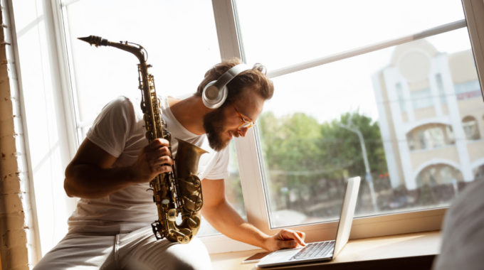 Man Playing Music On Laptop